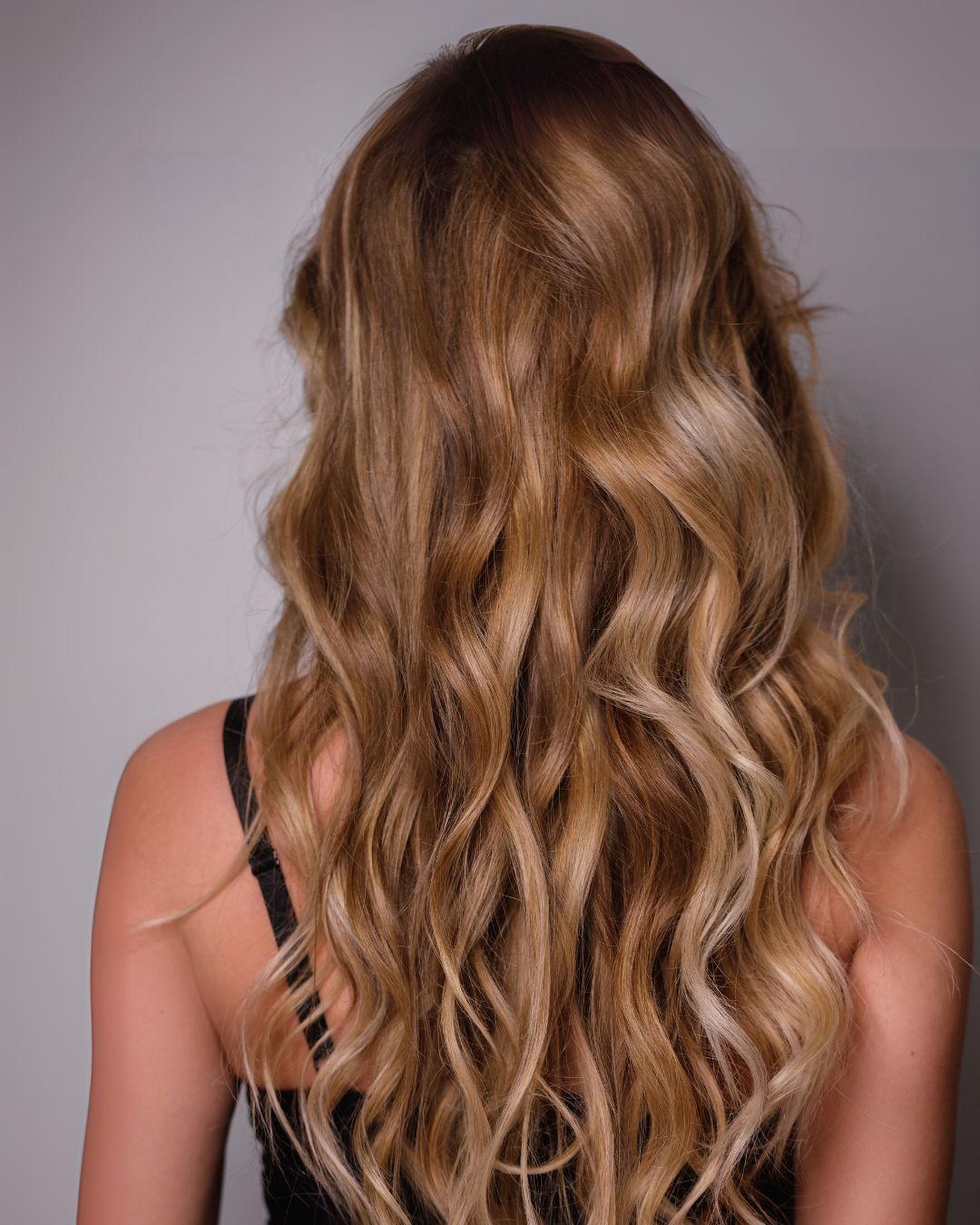 Soft waves styled to frame the face with gentle curves, creating a relaxed and feminine look that flatters square face shapes by softening strong angles